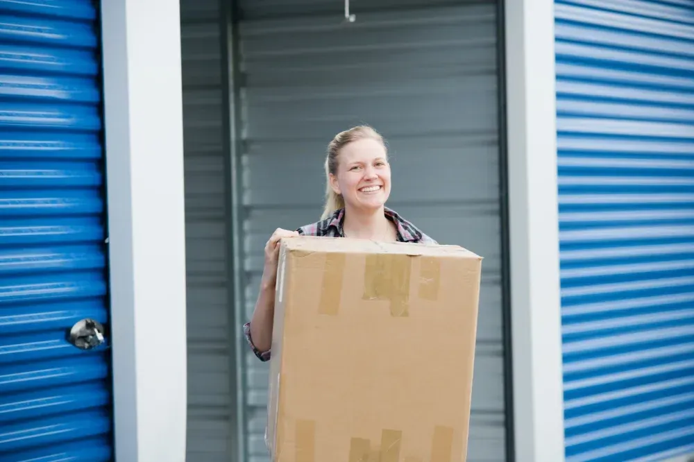 Someone bringing a box into a self storage unit in Zachary, LA