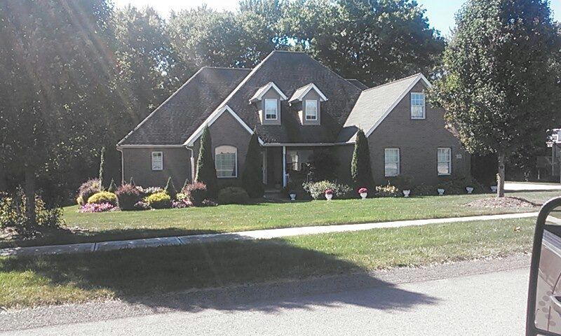 A large house with a lush green lawn in front of it