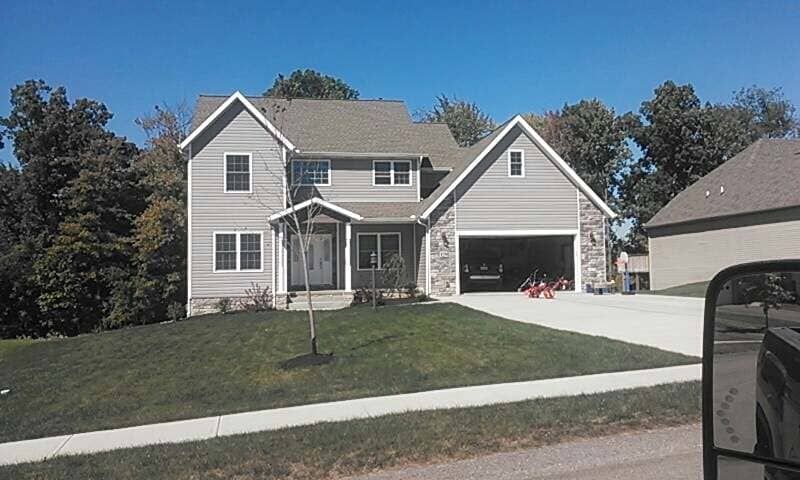 New Custom Built Large House With A Car Parked In Front
