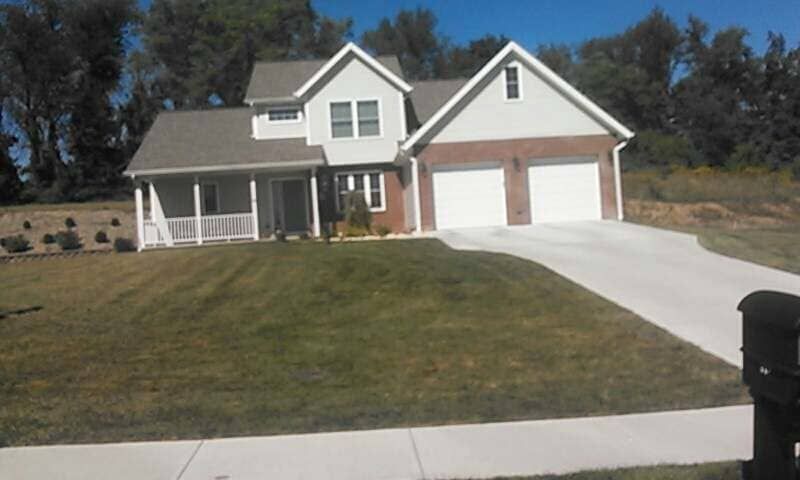 Custom Built House With Two Garages & A Driveway