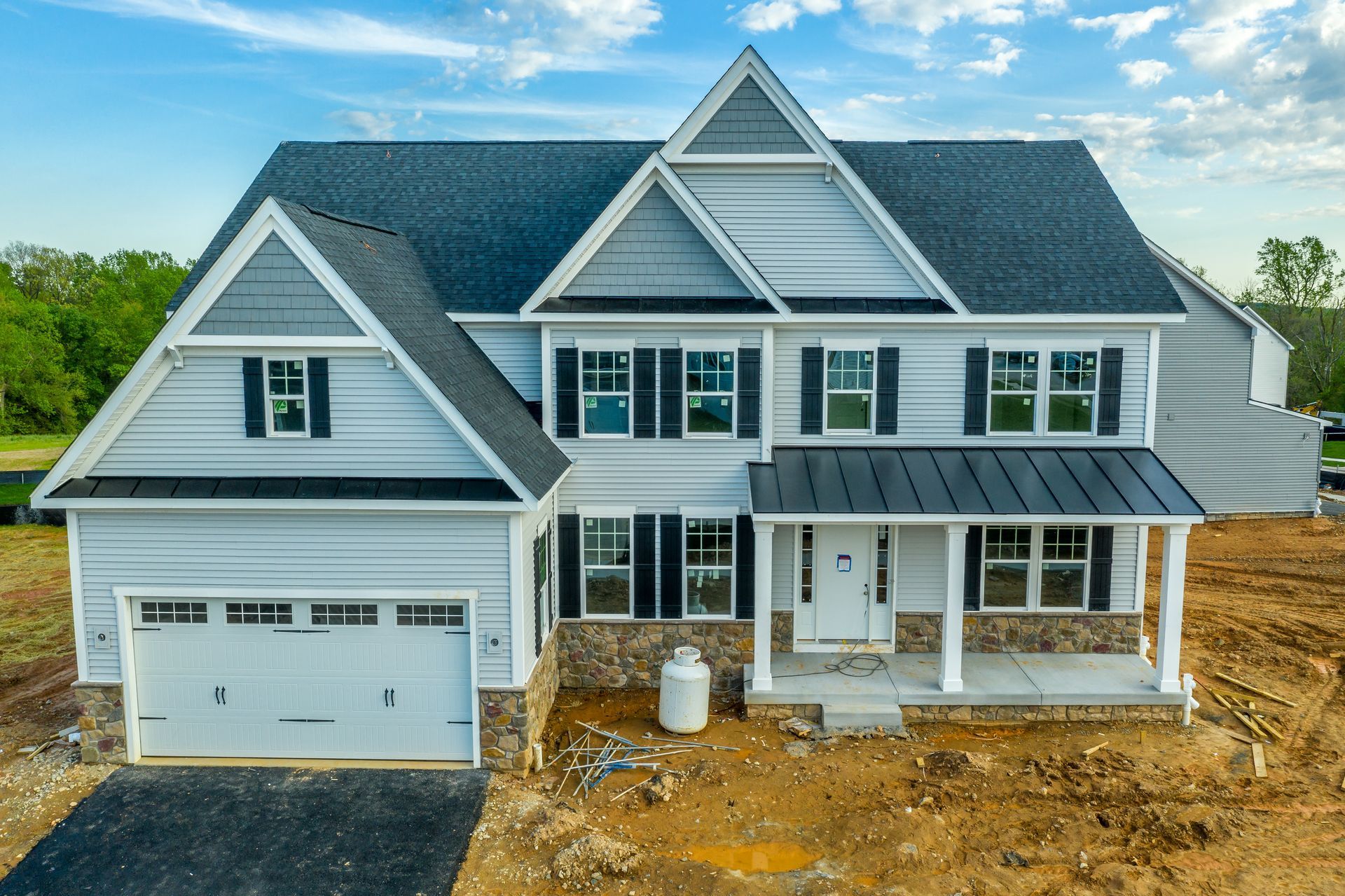 A home under construction by a custom home construction company at a large residential development.