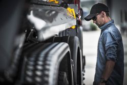 Man Checking Tires — Camp Douglas, WI — C. L. Chase 24 Hour Towing & Recovery Man Checking Tires — Camp Douglas, WI — C. L. Chase 24 Hour Towing & Recovery