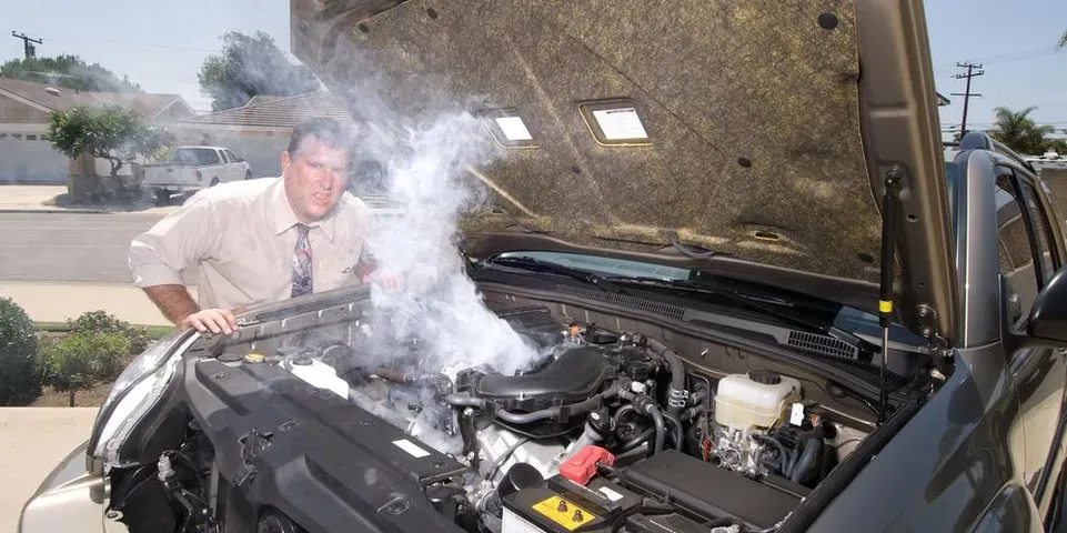 Man Looking At His Smoking Car Engine — Camp Douglas, WI — C. L. Chase 24 Hour Towing & Recovery