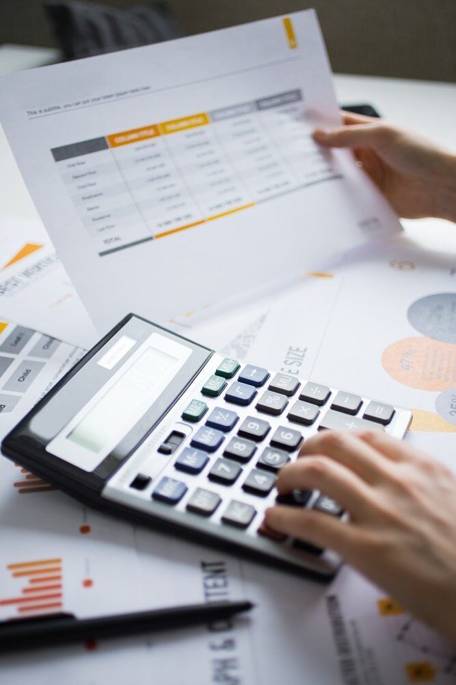 Hands Calculating With a Calculator — Fit Financial Group in Leumeah, NSW