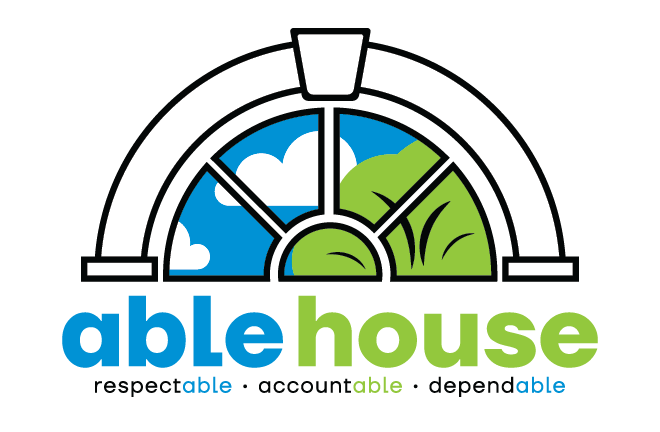 A logo for able house with a stained glass window