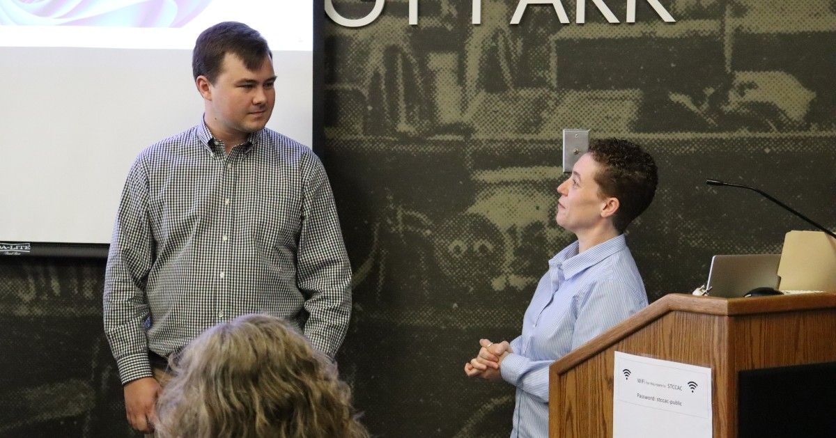 A man and a woman standing in front of a podium