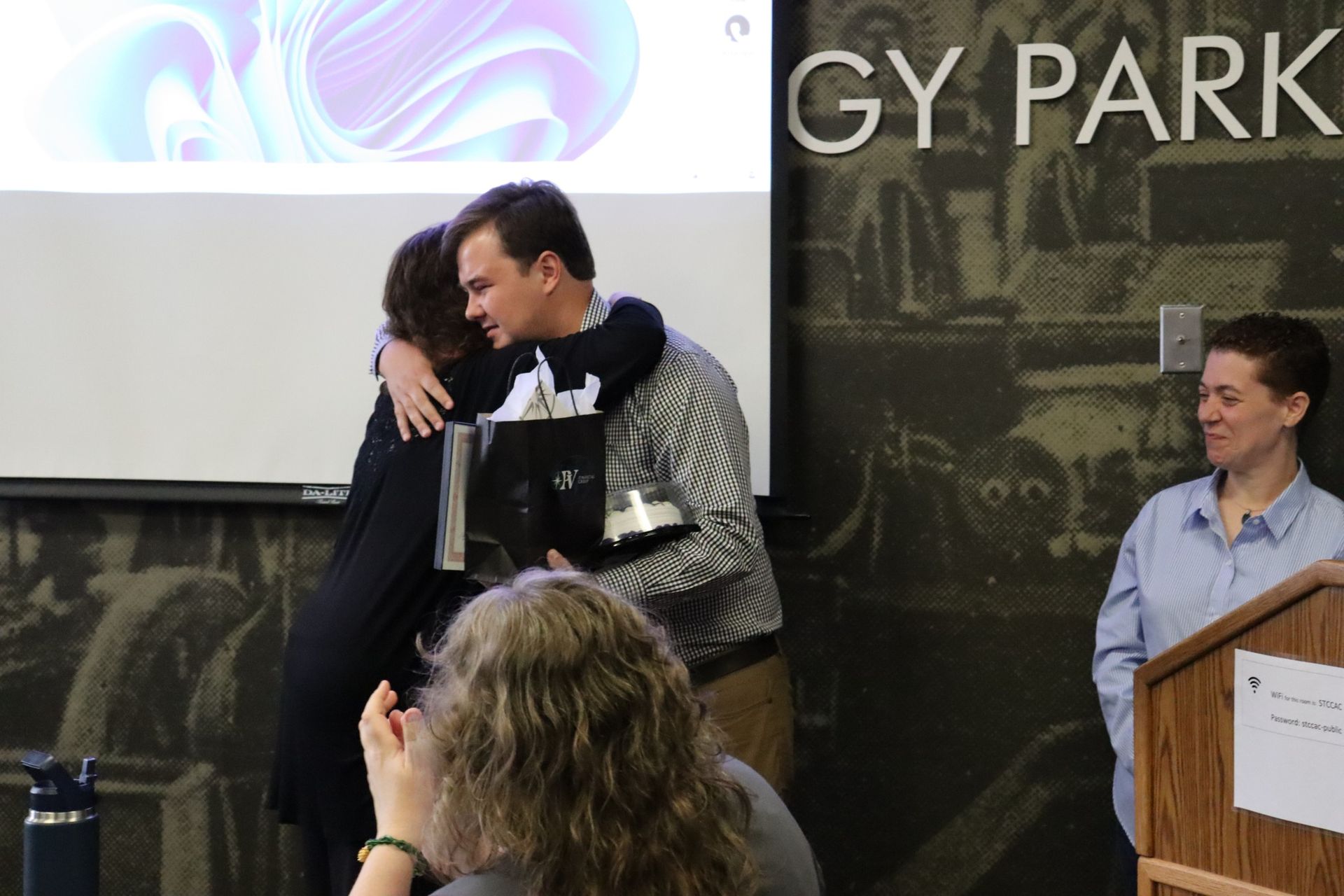 A man is hugging a woman