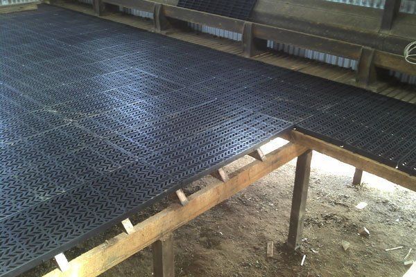 A rubber mat is sitting on top of a wooden floor.