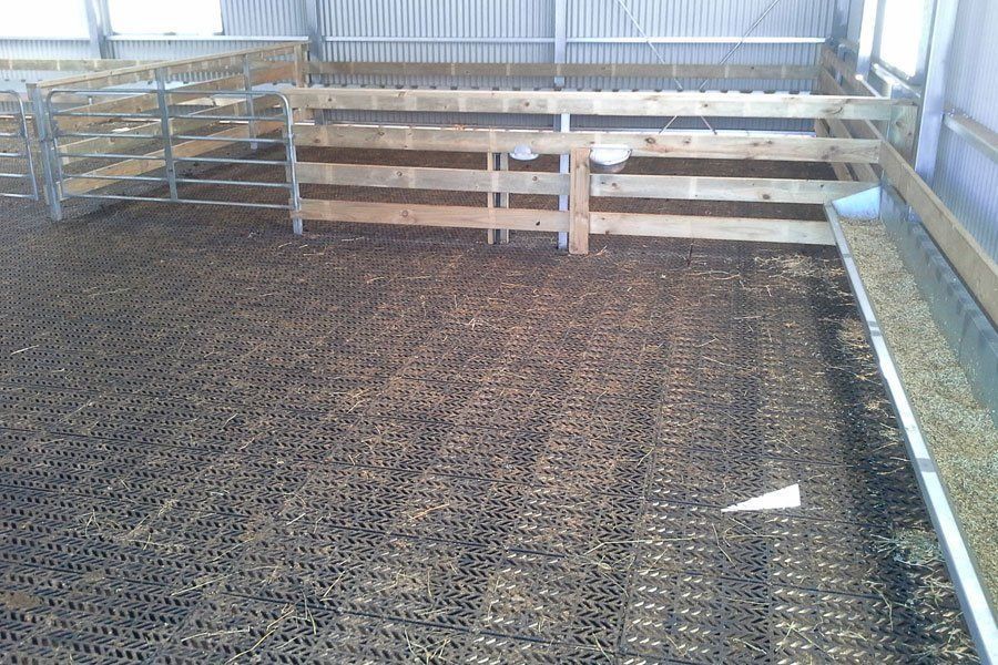A barn with a wooden fence and a wooden floor