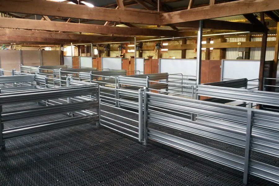 A large warehouse with a lot of shelves and fences