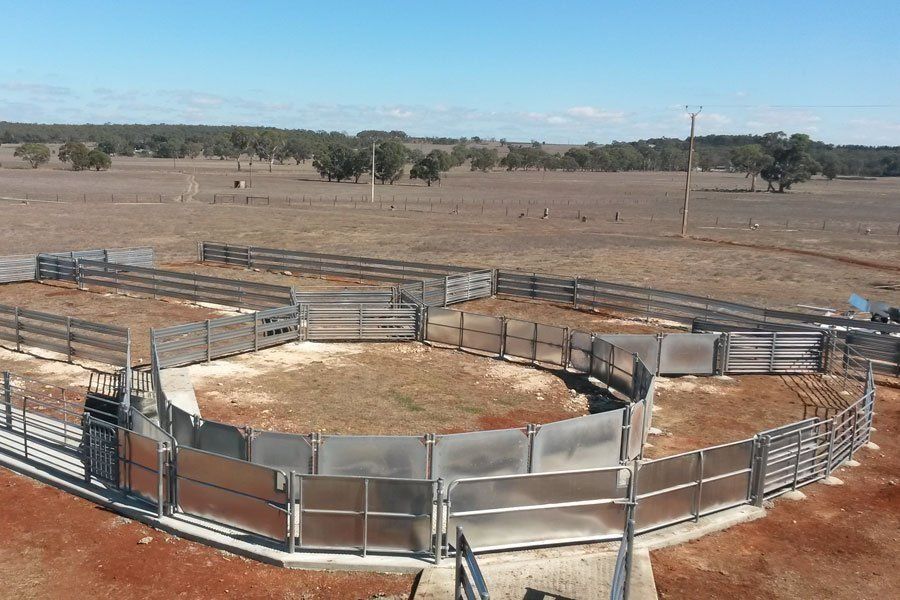 A fenced in area in the middle of a desert