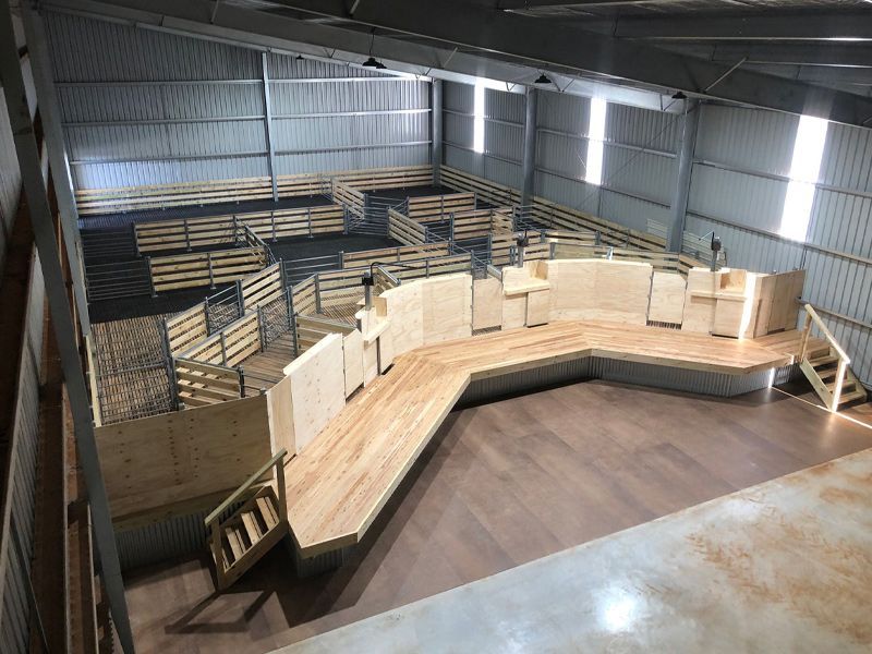 A large room with a wooden bench in the middle of it.