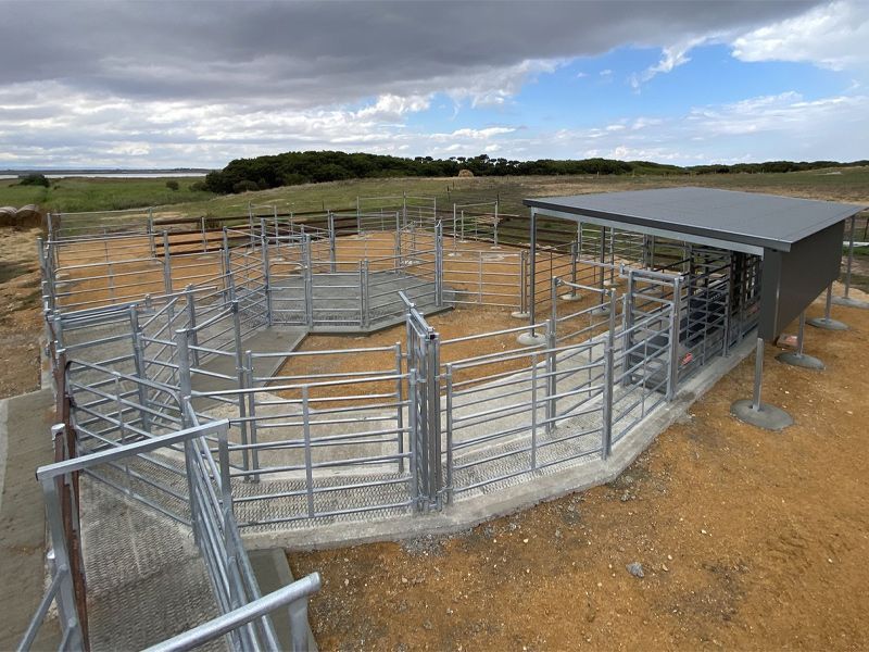 A fenced in area with a truck in the background.