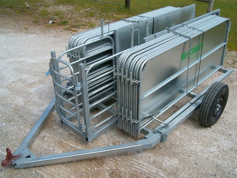 A trailer with a bunch of metal fences on it.