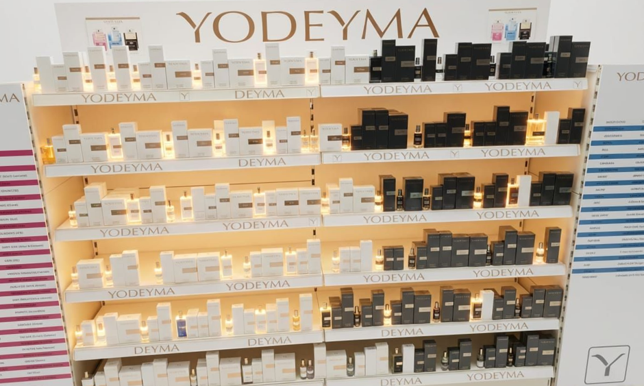 YODEYMA perfume display shelves with rows of white and black fragrance boxes in a store