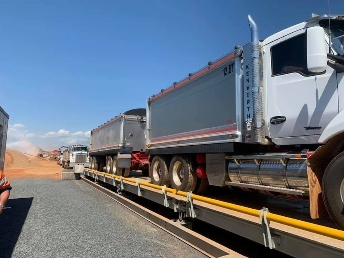 Line of Heavy Dump Trucks on a Highway — Barlow's Earthmoving in Rockhampton, QLD