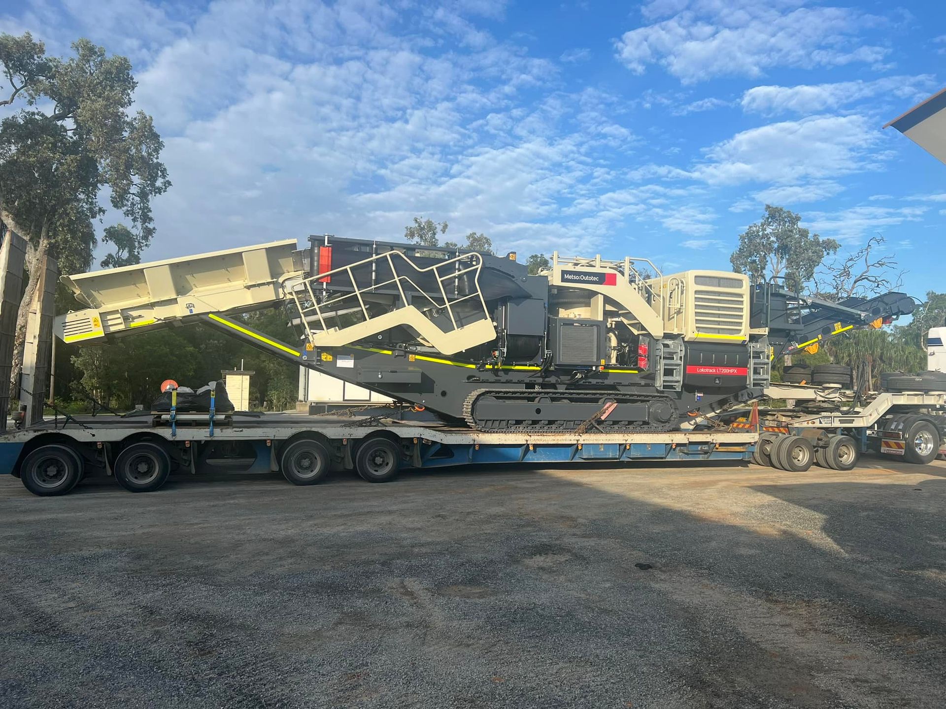 Large Industrial Machine on A Flatbed Trailer, Outdoors — Barlow's Earthmoving in Coorooman, QLD