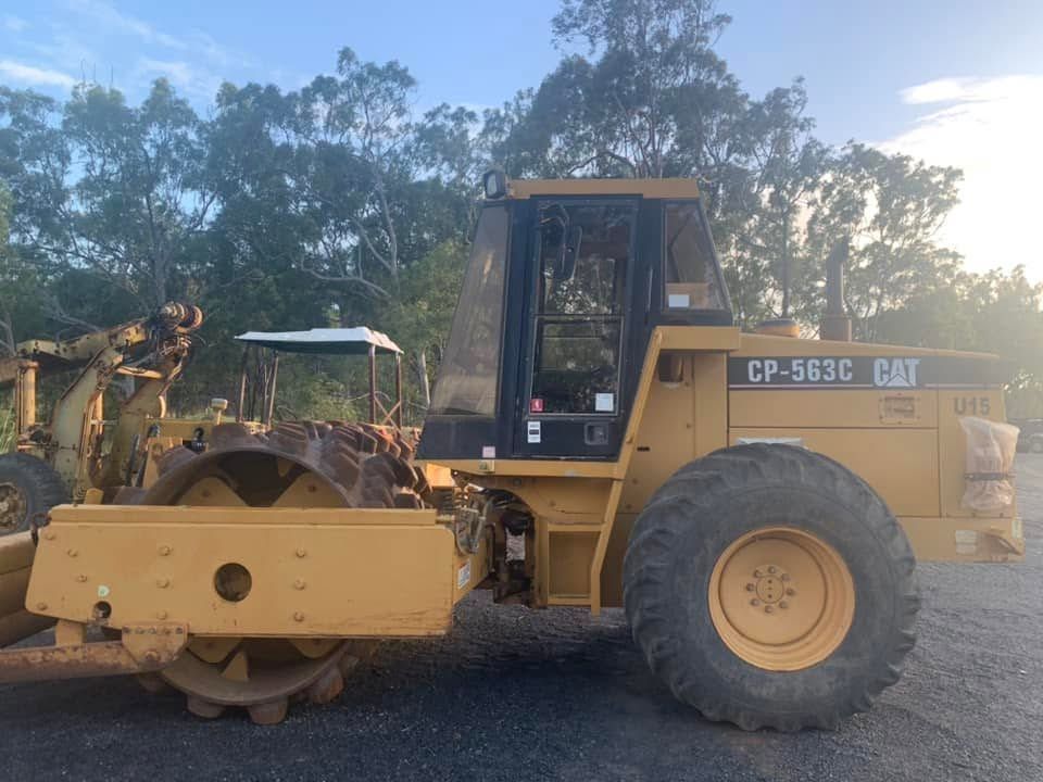 Yellow Road Roller Parked on a Dirt Road Beside Trees at Dusk — Barlow's Earthmoving in Coorooman, QLD
