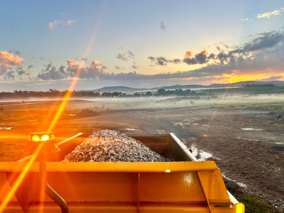 Orange Industrial Vehicle Dumping Gravel — Barlow's Earthmoving in Coorooman, QLD