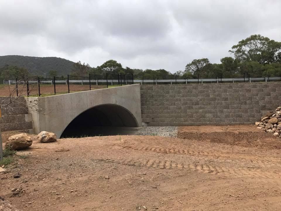 Concrete Culvert Under a Stone Retaining Wall in a Dry Dirt Landscape — Barlow's Earthmoving in Coorooman, QLD