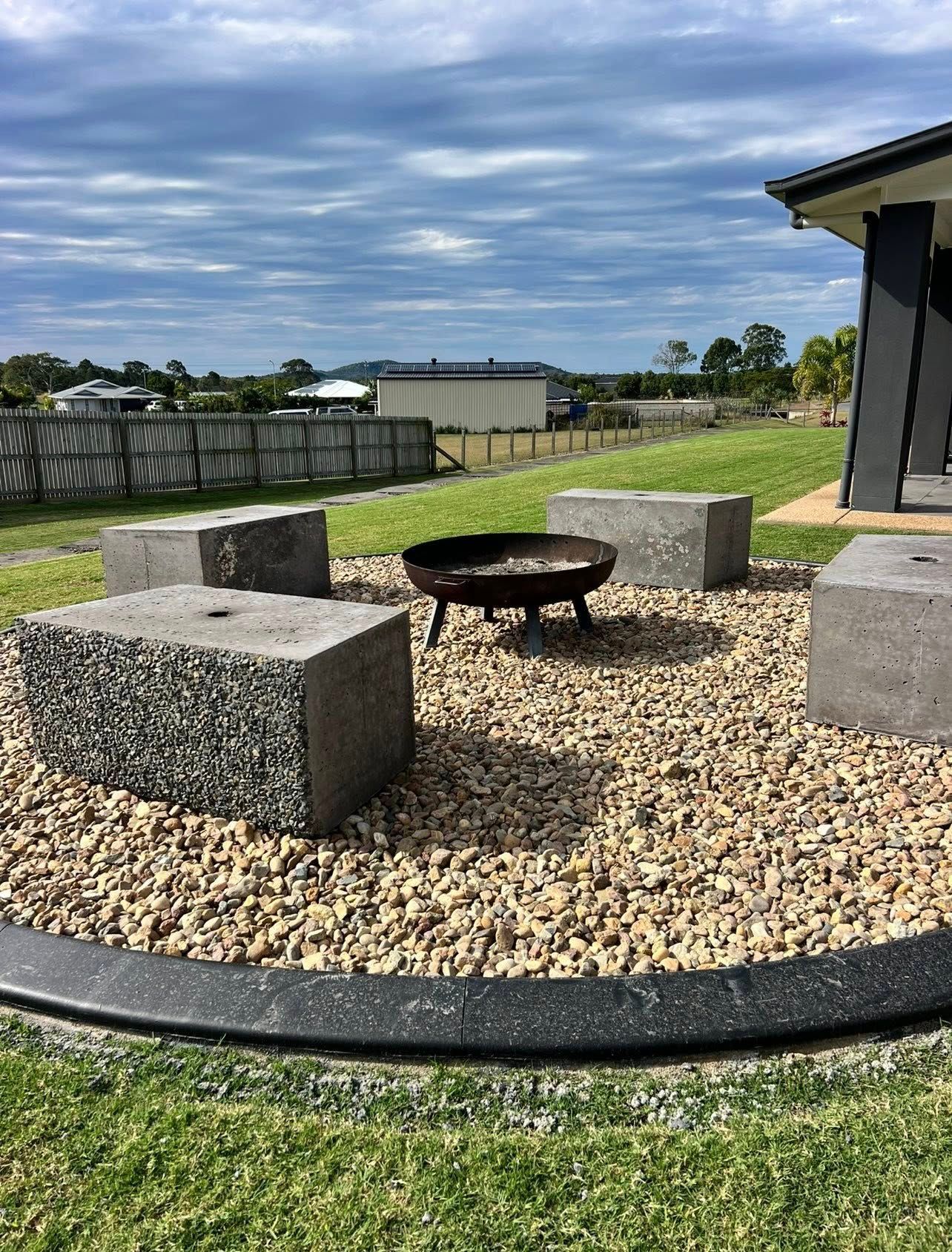 Fire Pit Area with Concrete Block Seating on Gravel — Barlow's Earthmoving in Coorooman, QLD