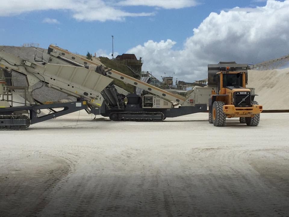 Yellow Forklift Beside a Large Industrial Conveyor on a Dusty Worksite — Barlow's Earthmoving in Coorooman, QLD