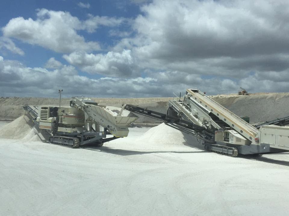 Two Conveyor Machines Unloading White Gravel Under a Cloudy Sky in a Quarry — Barlow's Earthmoving in Coorooman, QLD