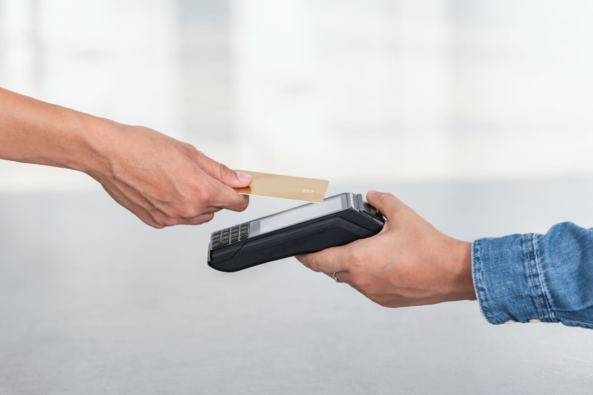 A person is using a credit card to pay for something.