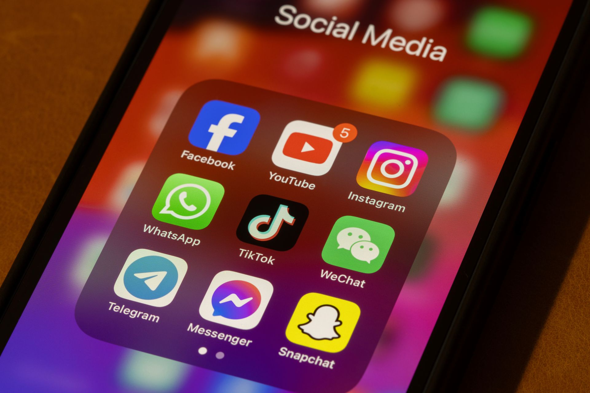 A phone with a bunch of social media apps on it