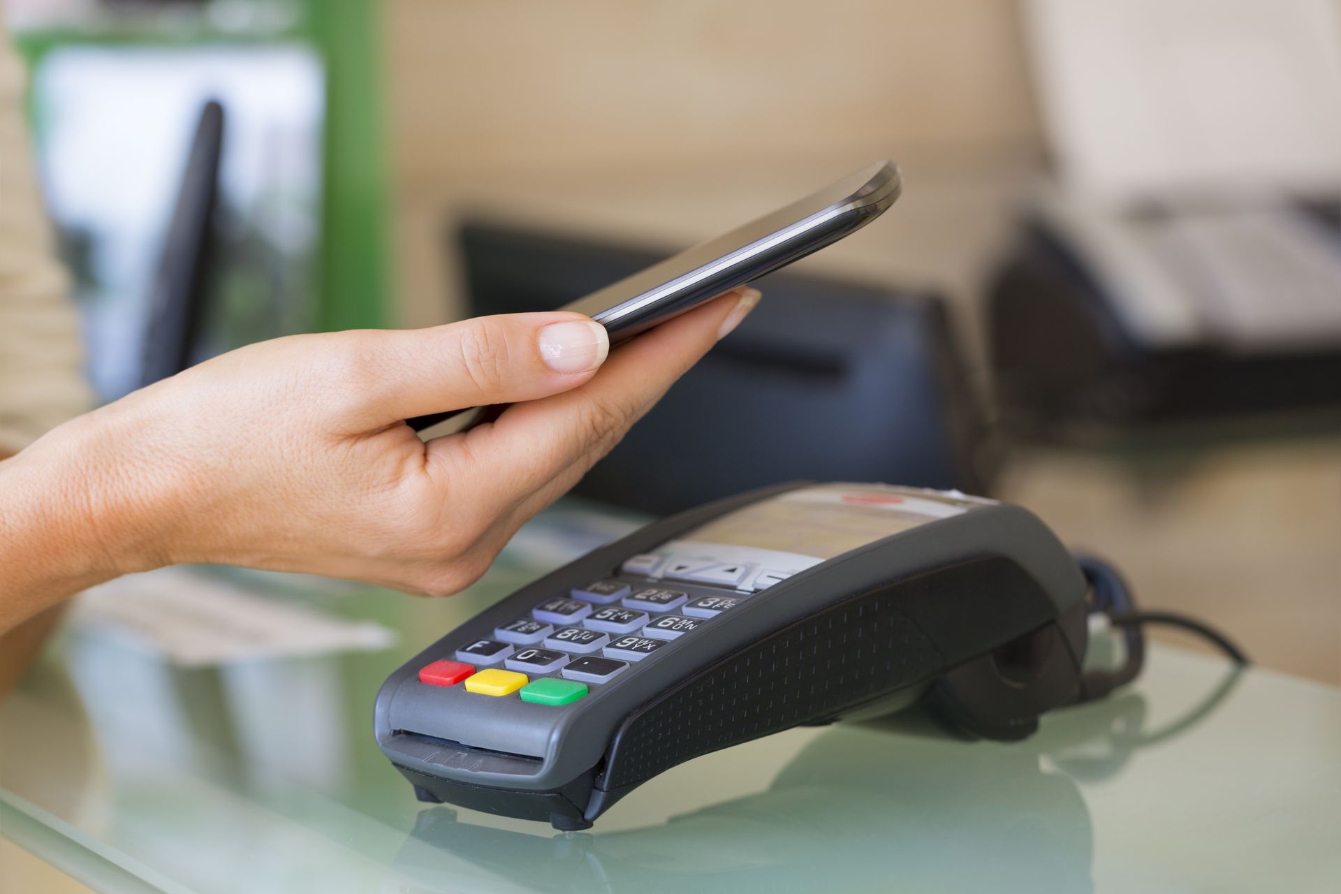 A person is using a smart phone to pay with a credit card machine.