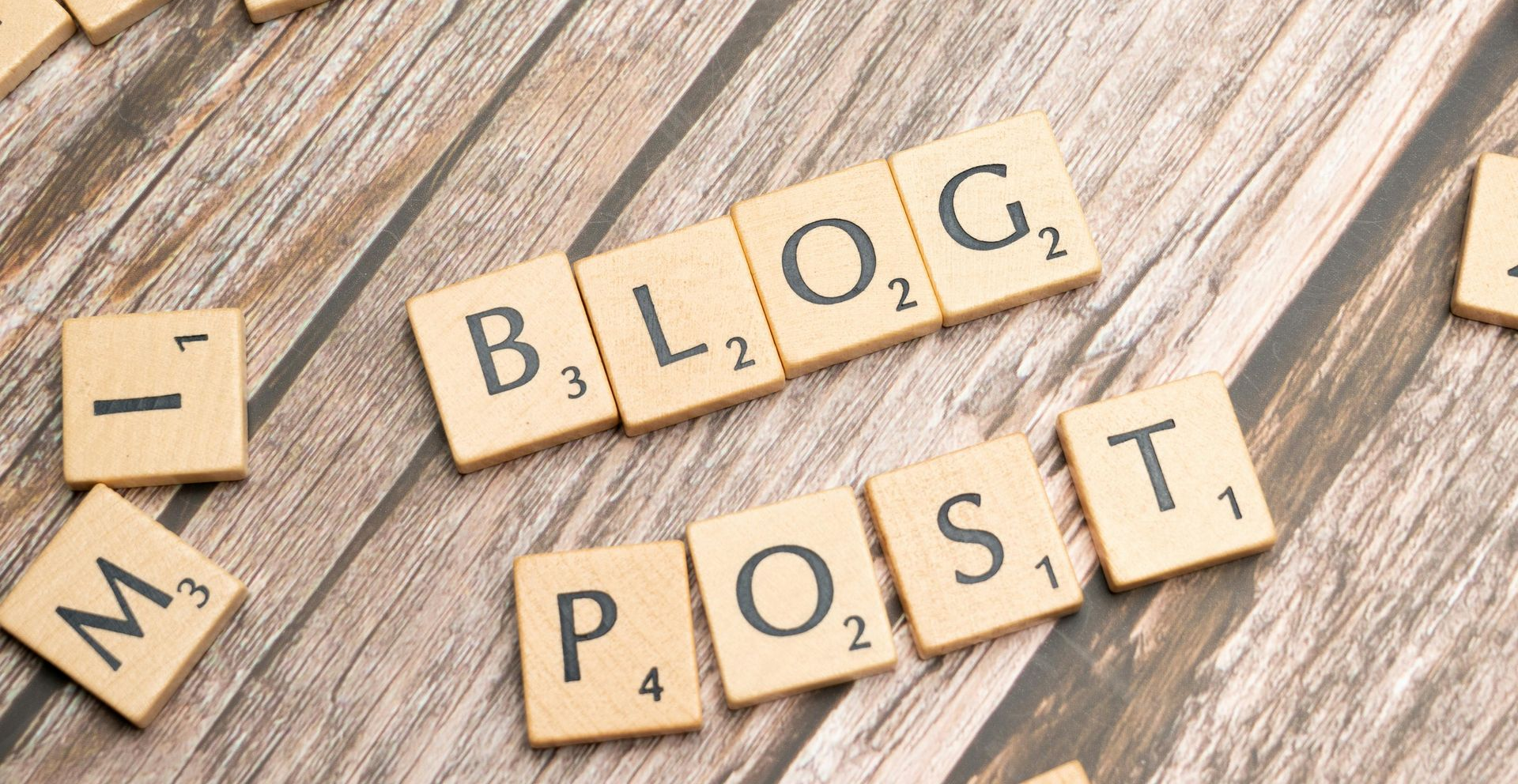Scrabble tiles spelling “BLOG POST” on a wooden surface