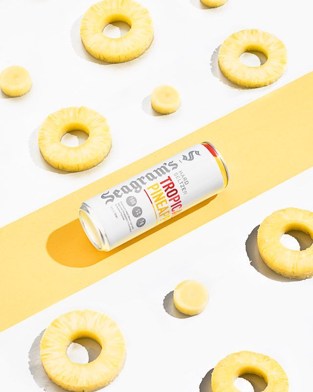 Food and beverage photography of Seagram's Tropical Pineapple Hard Seltzer with pineapple fruit rings. Product photography by JAM Creative for Seagram's Hard Seltzer/FIFCO USA.
