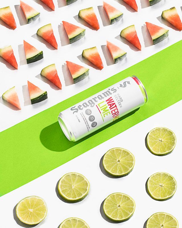 Food and beverage photography of Seagram's Watermelon Lime Hard Seltzer with watermelon wedges and lime slices. Product photography by JAM Creative for Seagram's Hard Seltzer/FIFCO USA.