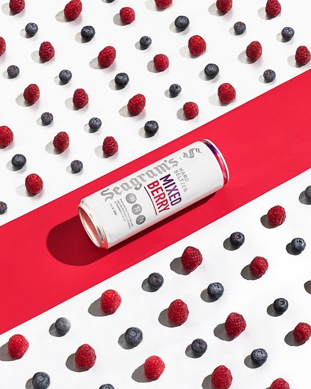 Food and beverage photography of Seagram's Mixed Berry Hard Seltzer with raspberries and blueberries. Product photography by JAM Creative for Seagram's Hard Seltzer/FIFCO USA.