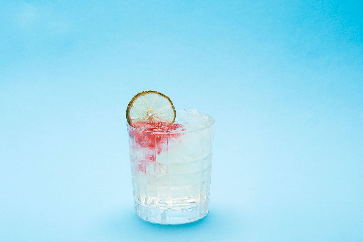 Beverage product photography of cocktail with lime and blood like mixer on blue paper For Stonecutter Spirits by JAM Creative