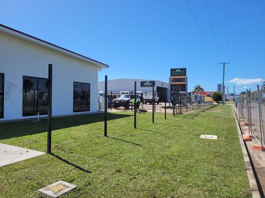 Exterior of Commercial Building with Lawn and Metal Posts — Top Notch Turf in Rasmussen, QLD