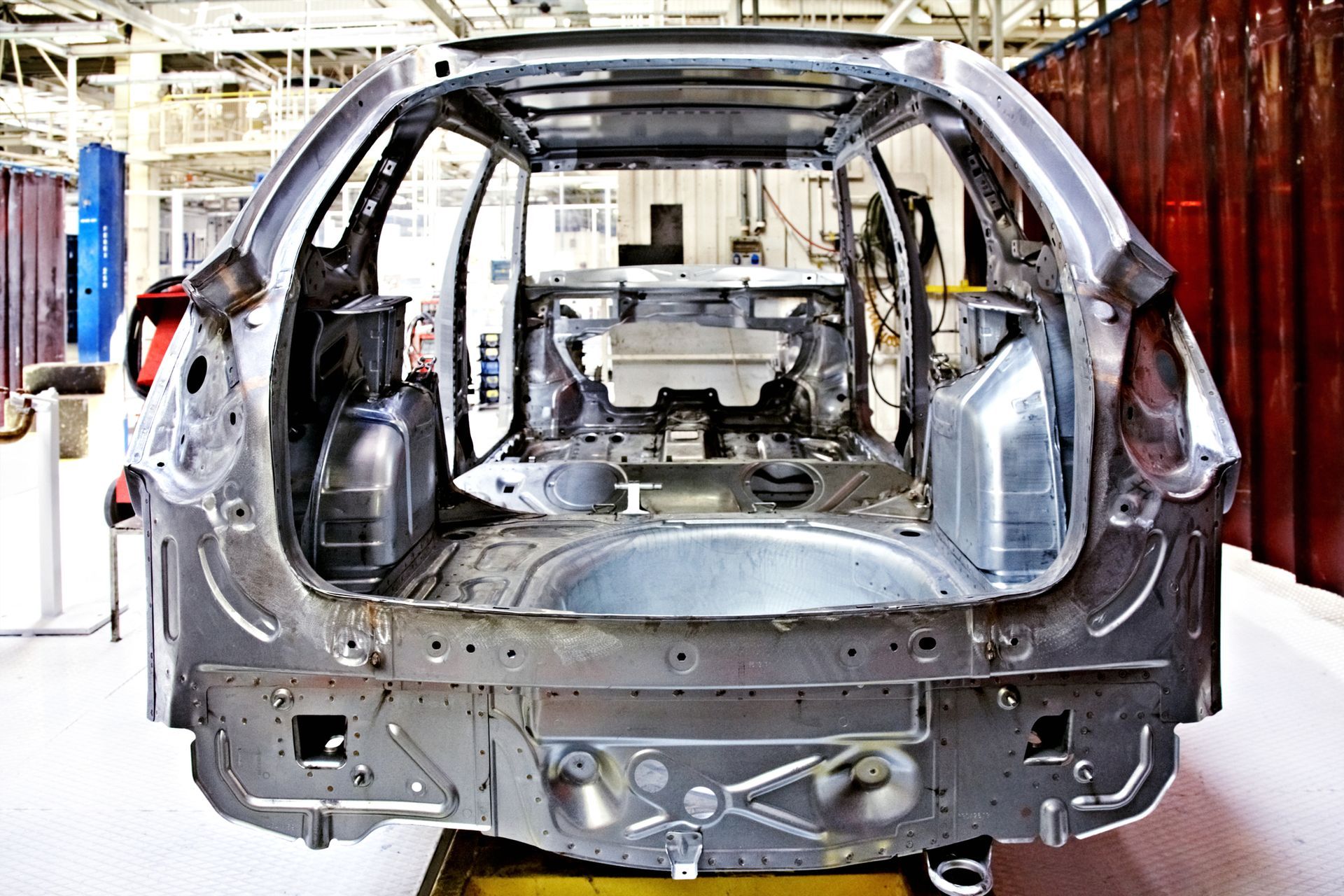 A car is being assembled in a factory.