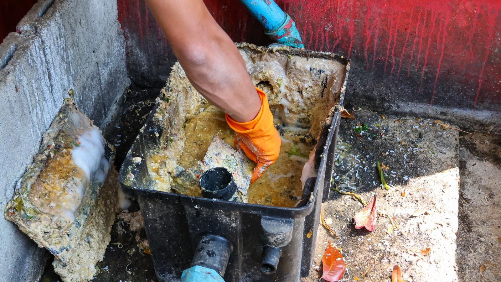 Professional cleaning grease trap.