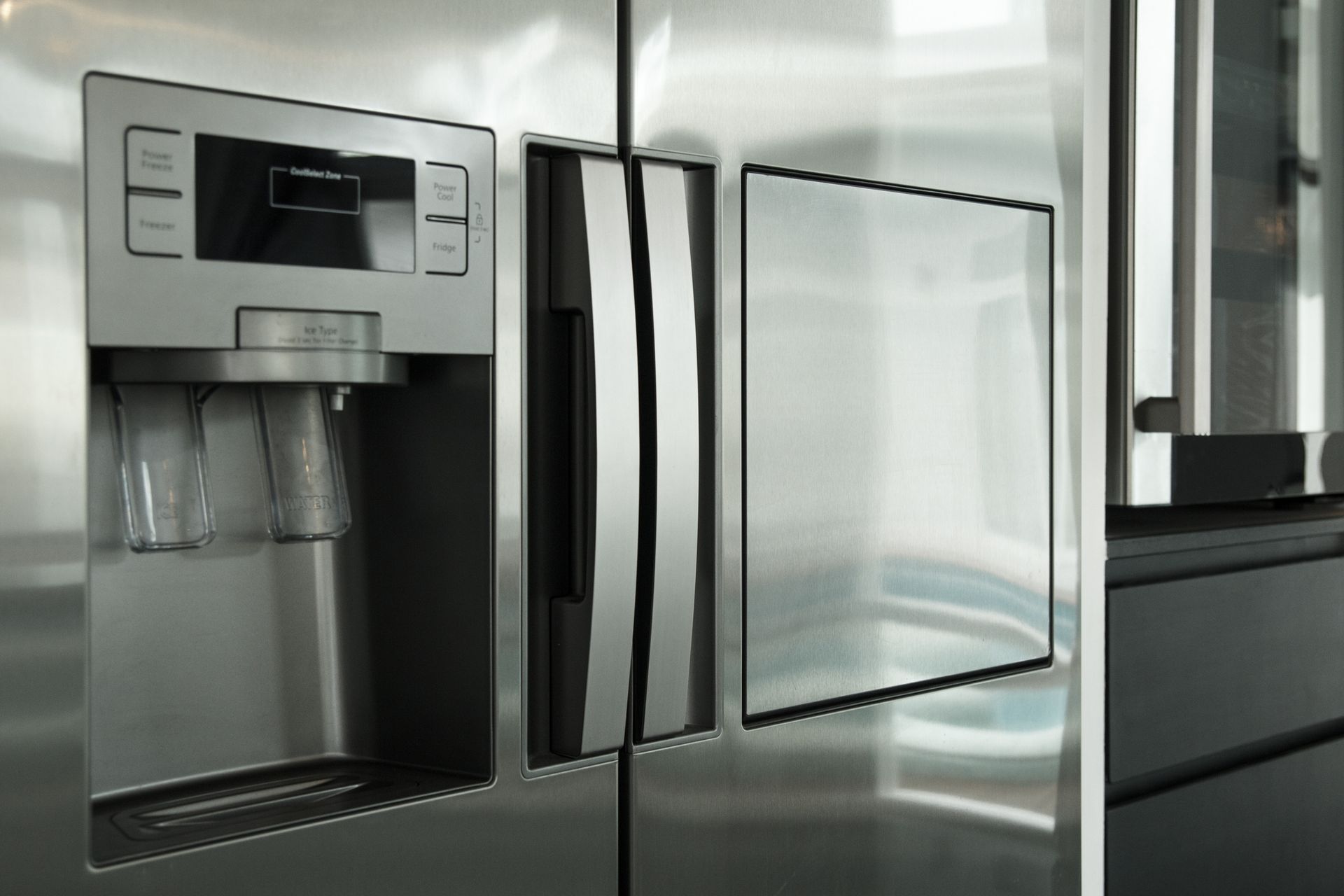 A stainless steel refrigerator with a water dispenser