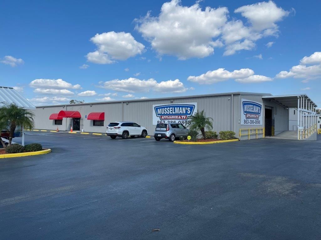 Musselman 's appliance and tire store with a group of people standing in front of it