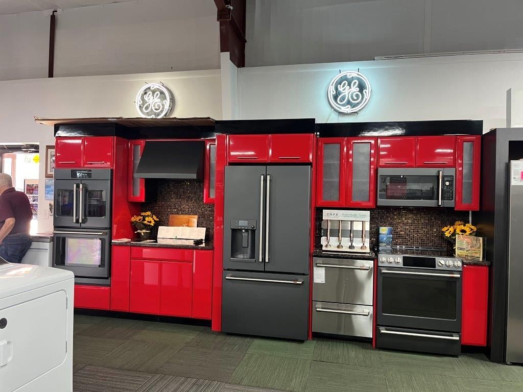 A kitchen with white cabinets and a stainless steel refrigerator.