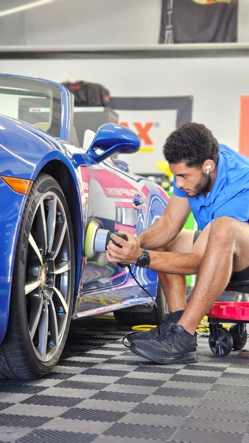 A CarZmedics paint protection specialist paint correcting a Porsche.