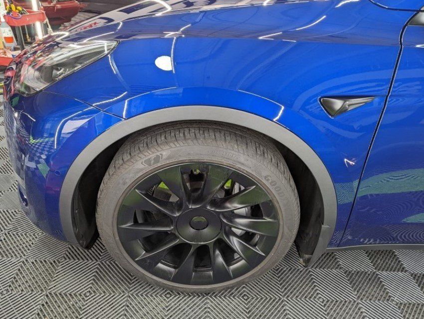 Tesla after receiving paint protection film (PPF) installation on the fender