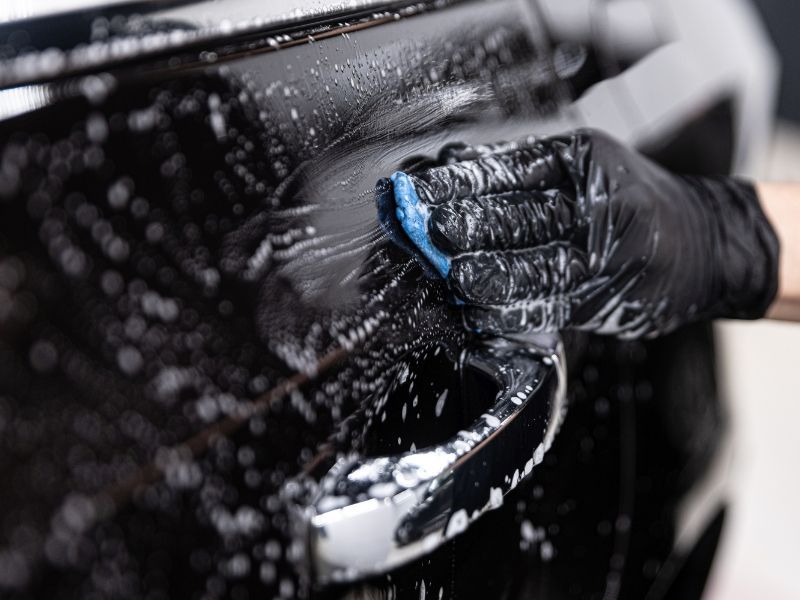 Car undergoing decontamination wash prior to paint protection film installation.