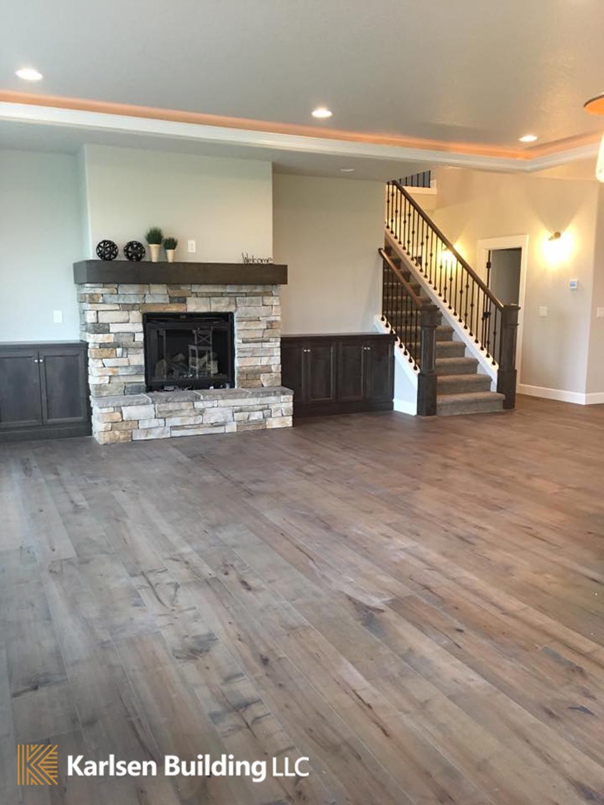 A living room with a fireplace and stairs.