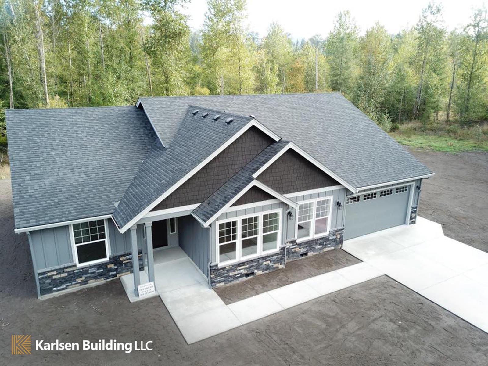 An aerial view of a house with a black roof