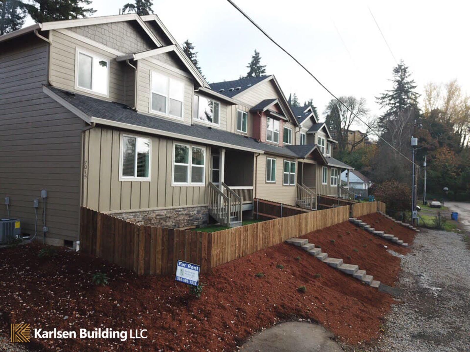 A row of houses with a sign that says kirken building llc