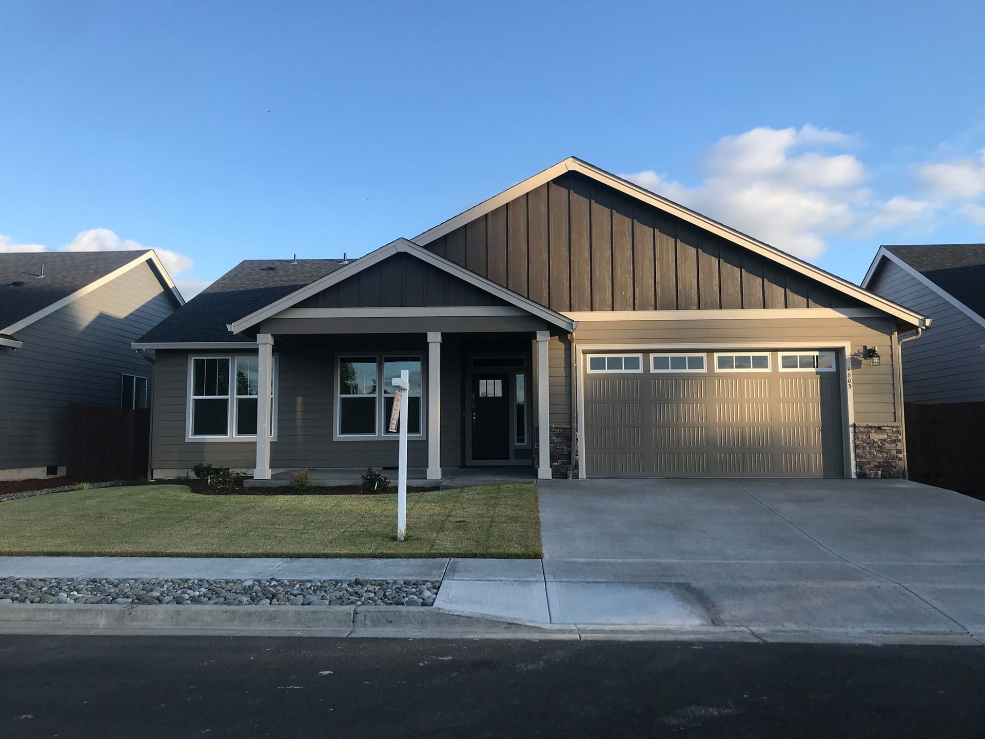 The front of a house with a garage and a porch.