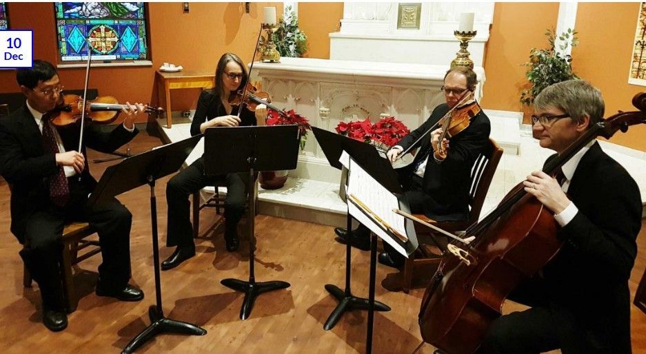 A group of people are playing violins and cello in a church.