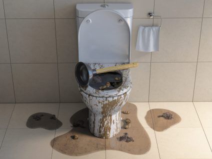 Damaged toilet overflowing with water and debris in a tiled restroom